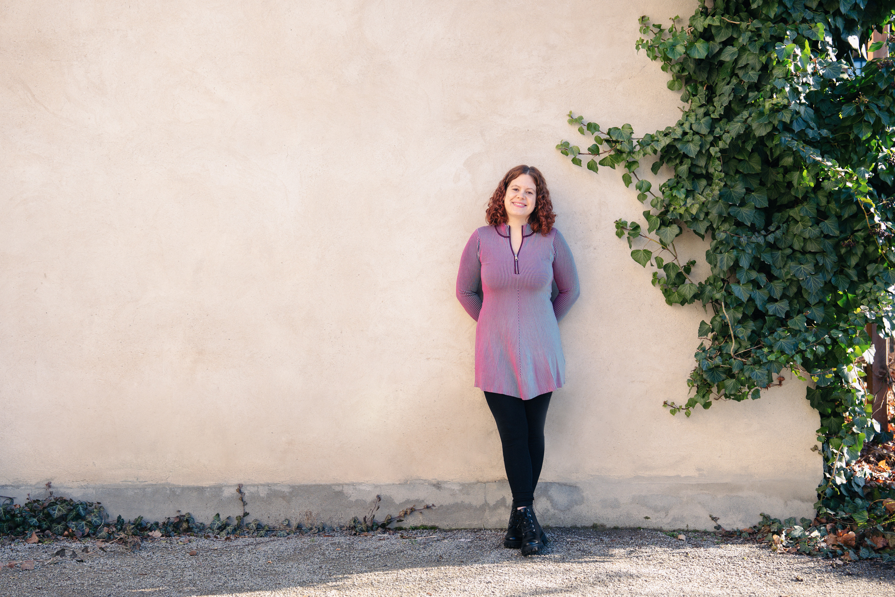 Psychotherapeutin vor einer Wand mit Efeu